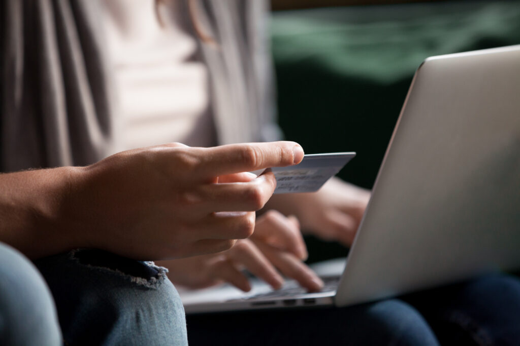 a man holding a credit card beside a woman