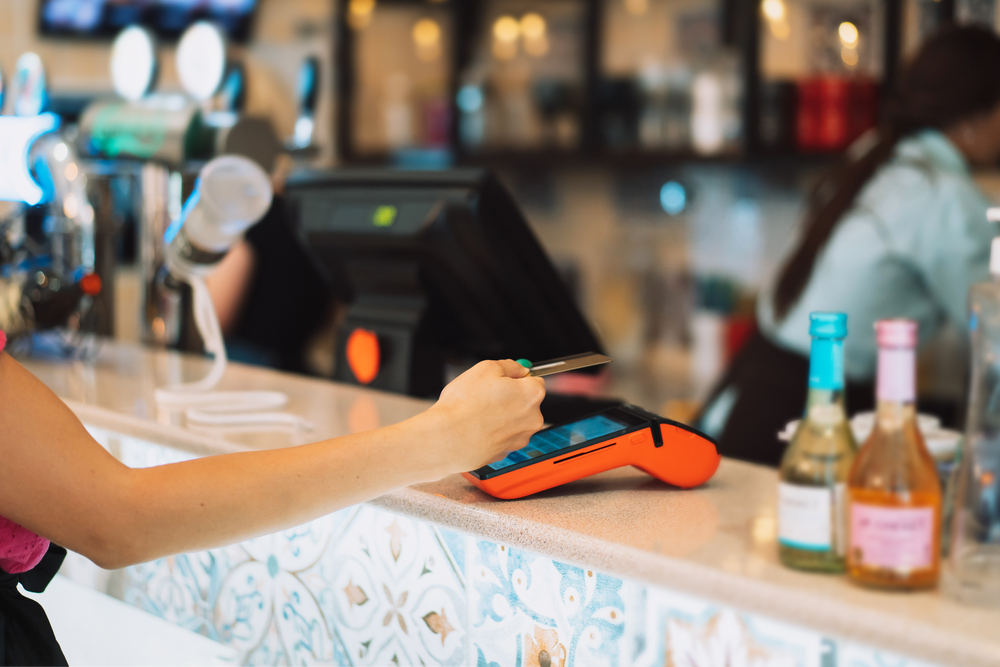 a woman paying using her credit card