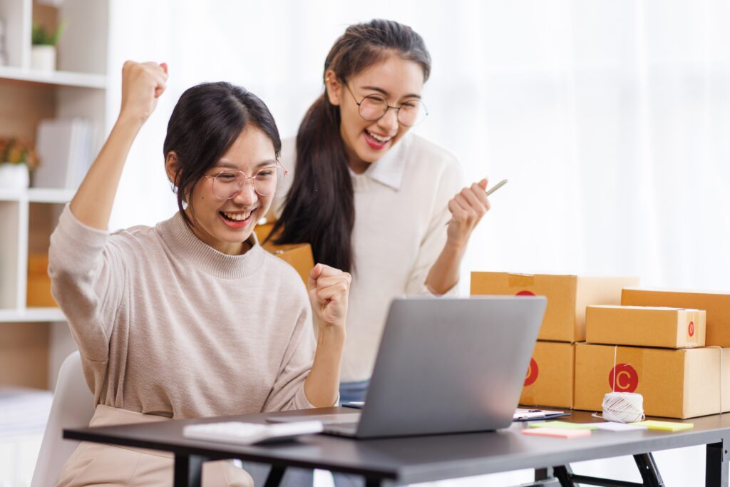 two online business owners cheering