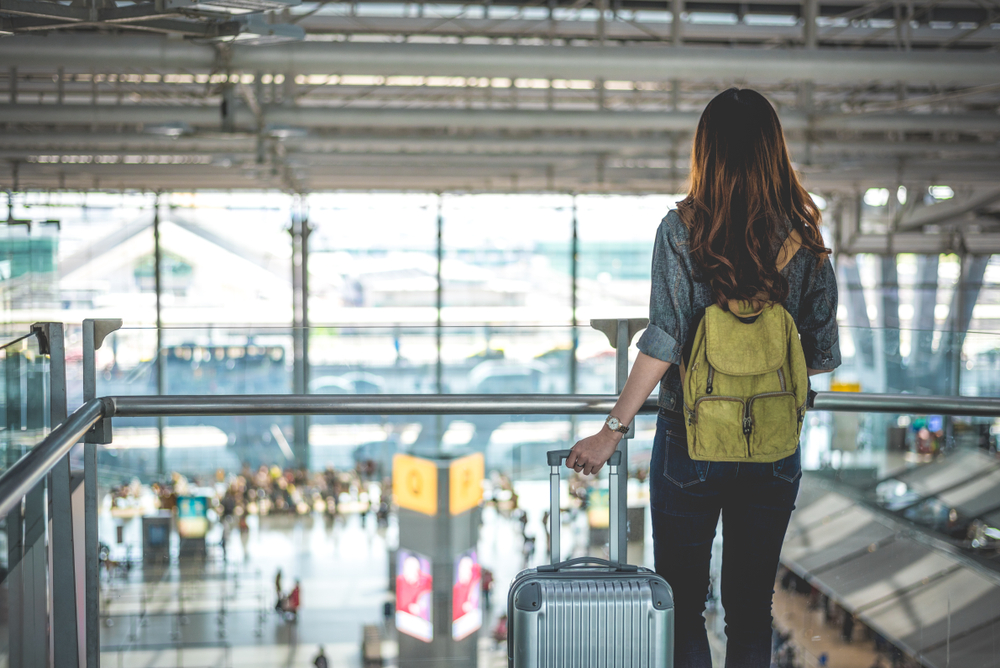 a woman watching the people in the airport