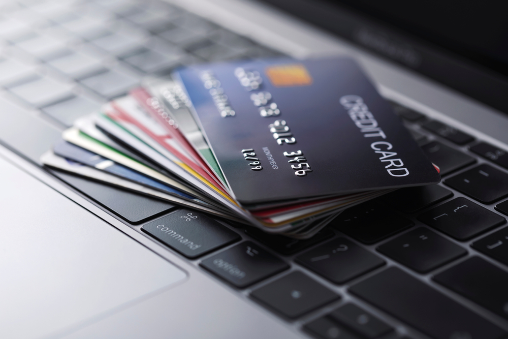 multiple credit cards placed on top of a keyboard