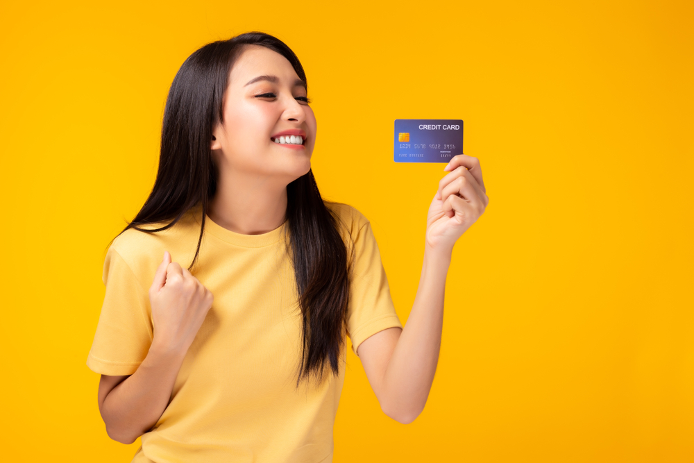 a woman holding a credit card