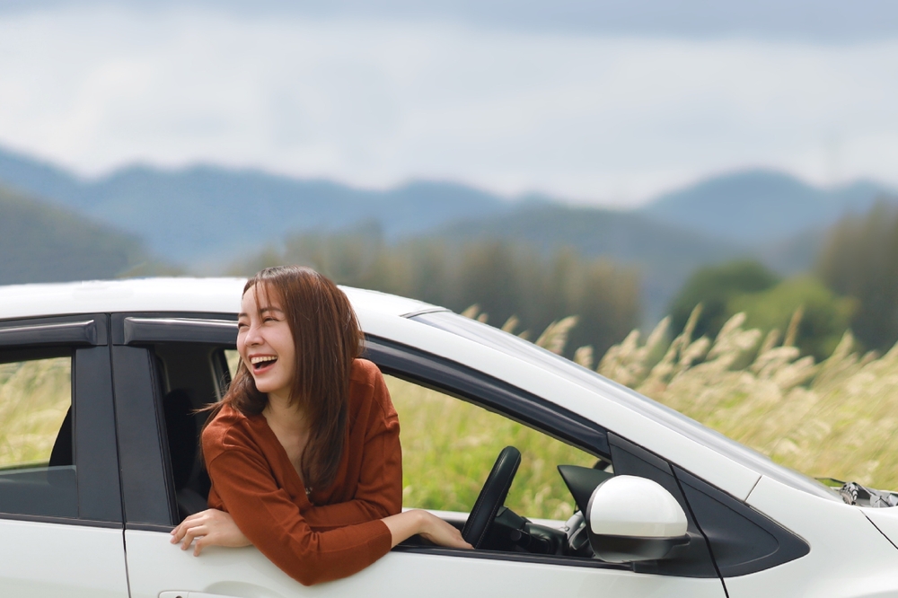a woman in a car smiling